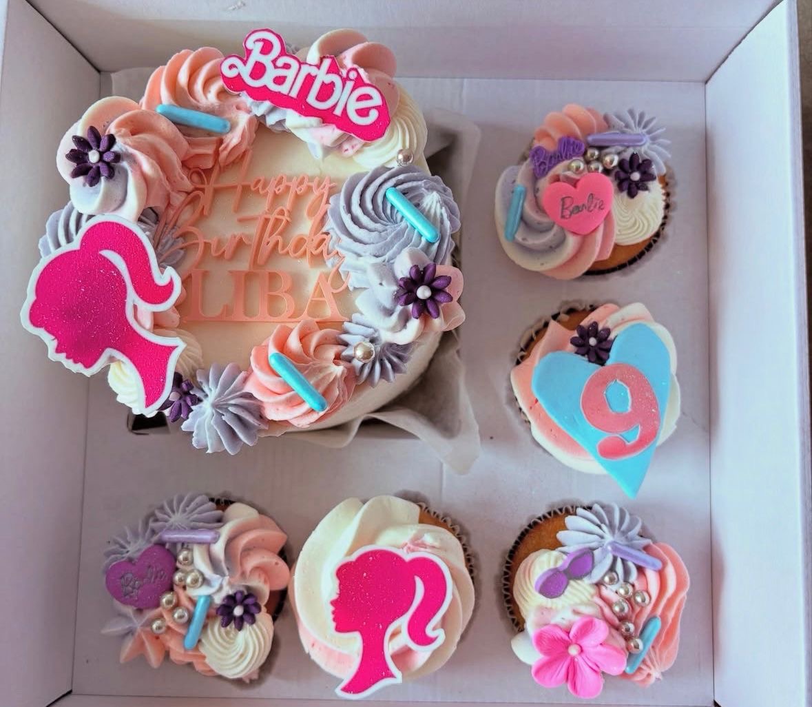 Barbie themed pink bento birthday cake with matching cupcakes for a girl's birthday celebration